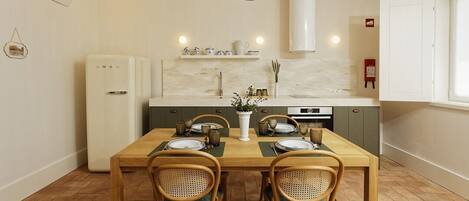 A compact kitchen with a dining table set for four, equipped with a refrigerator, a stove, and a hanging light fixture.