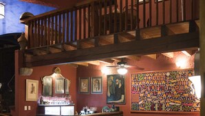 A cozy room with a wooden staircase, a vintage gramophone, and a colorful mosaic wall. - Orchidelirium Casa Hotel & Salud Estetica (Cuernavaca)