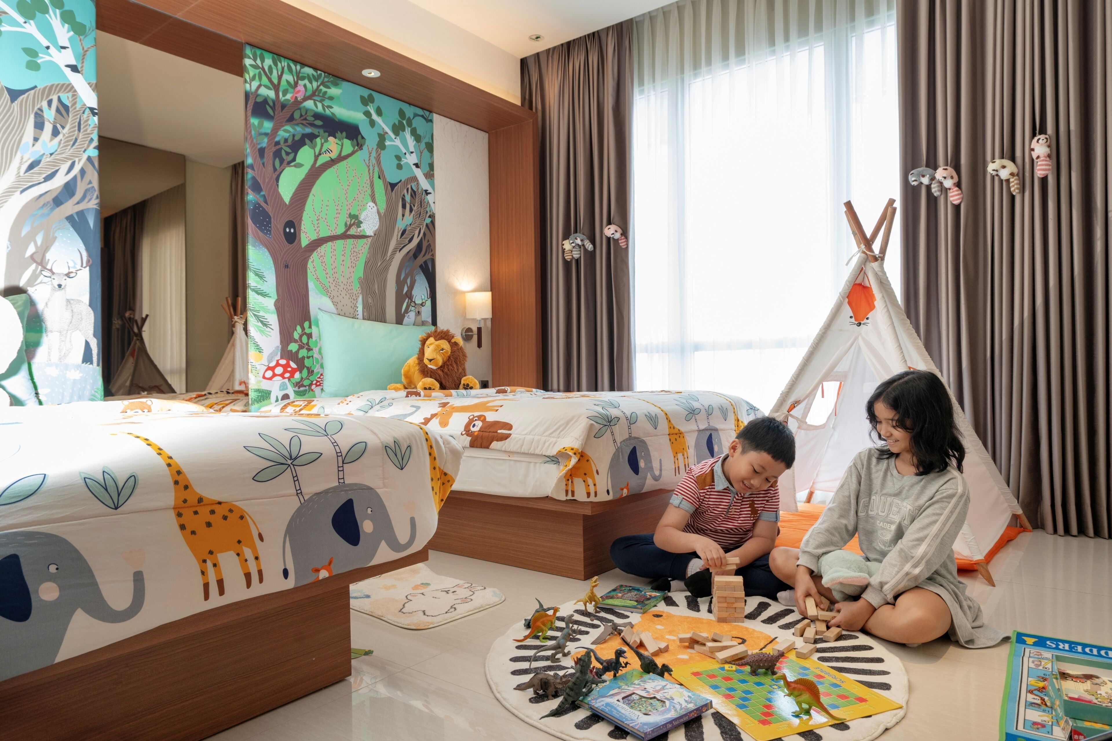 A children's room with two beds, a teepee, and various toys.