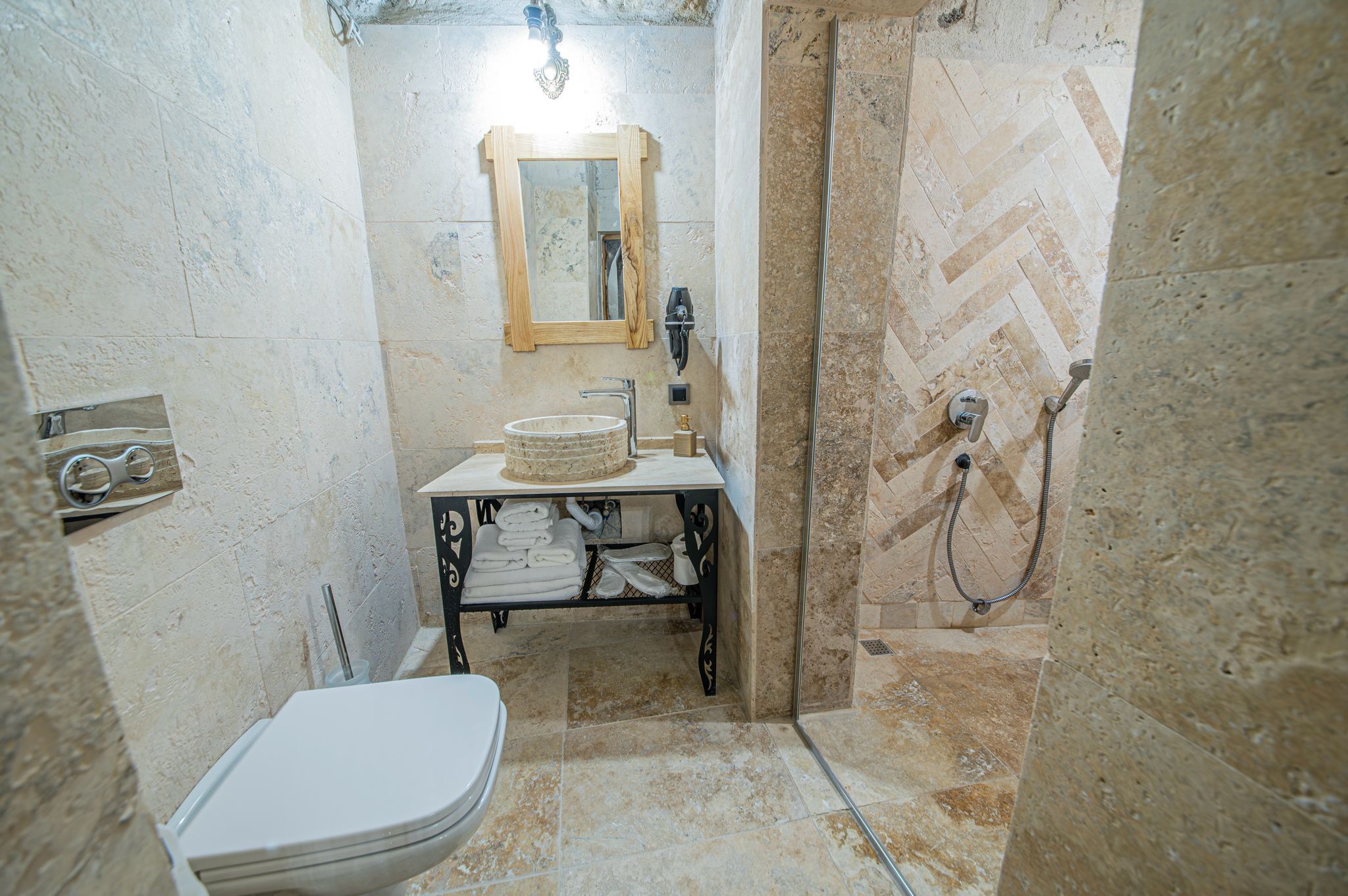 A bathroom with a toilet, sink, and shower.
