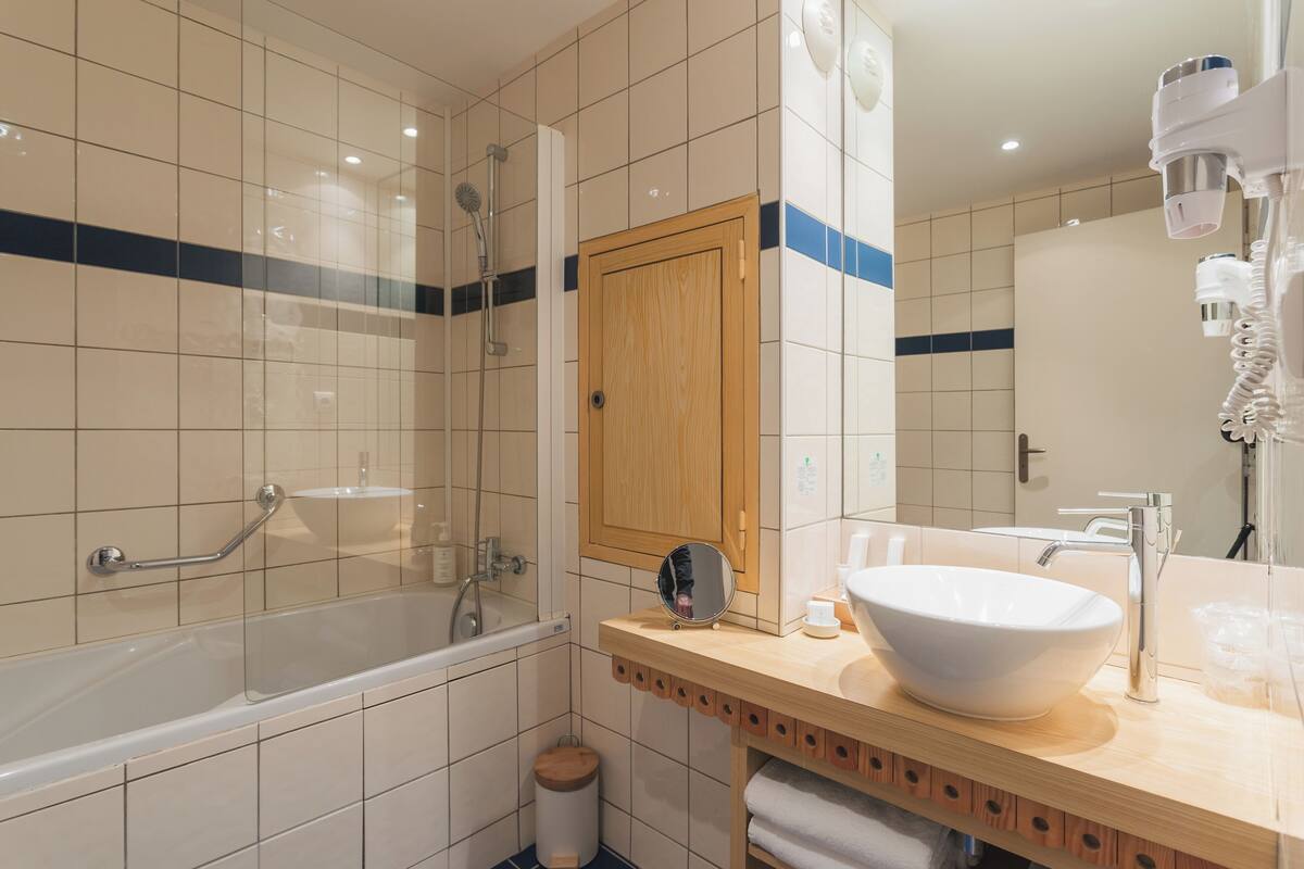 superior triple room | bathroom | bathtub, eco-friendly toiletries, hair dryer, bathrobes
