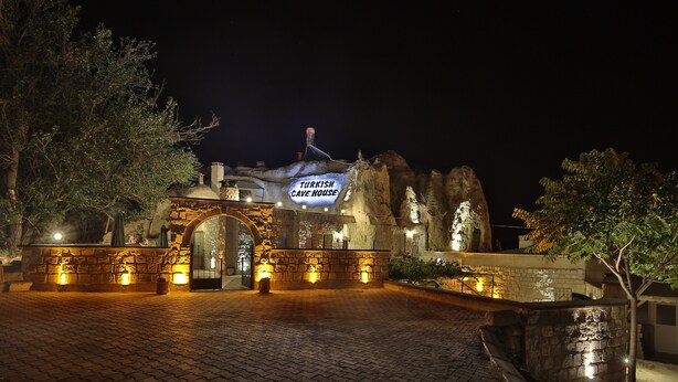 A stone building with a sign reading "Turkish Cave House" at night. - Turkish Cave House (Ürgüp)