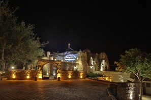 A stone building with a sign reading "Turkish Cave House" at night. - Turkish Cave House (Ürgüp)