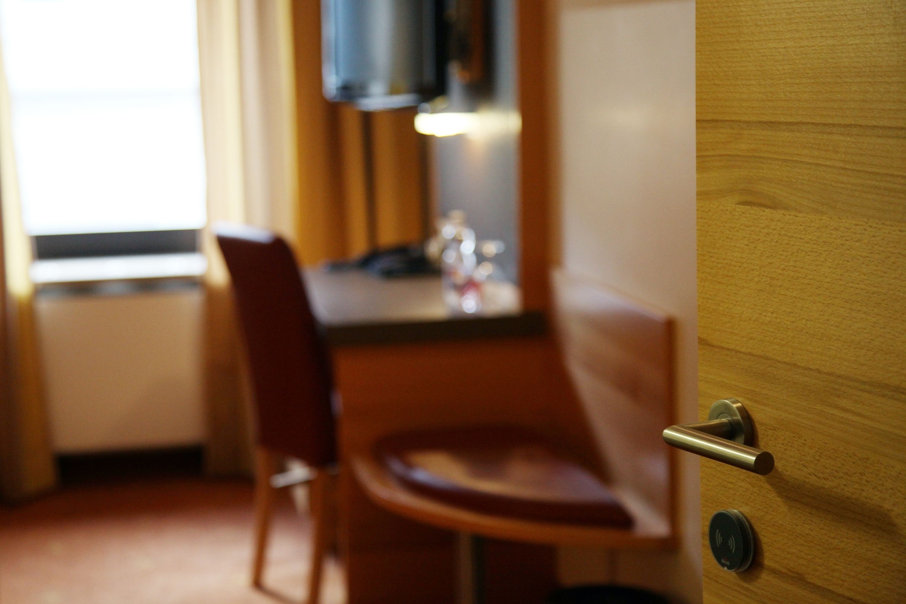 A wooden door with a handle and a lock.