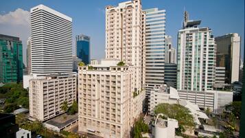 A high-rise building with a modern architectural design, featuring multiple floors and a prominent central tower.