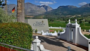 A sign for Val du Charron wine and leisure estate with a mountainous backdrop. - The Coach House at Val du Charron (Wellington)