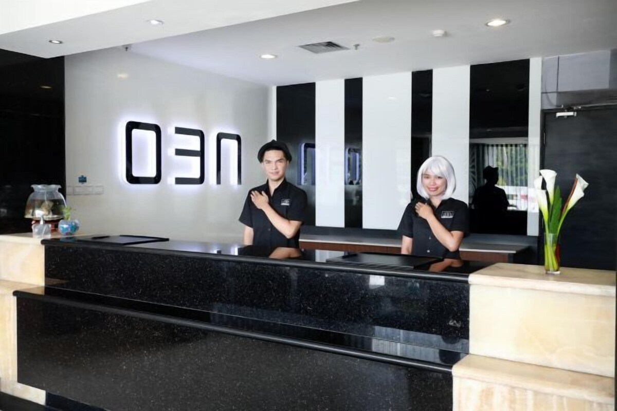 A reception desk with a black marble top and a digital sign displaying '03'.