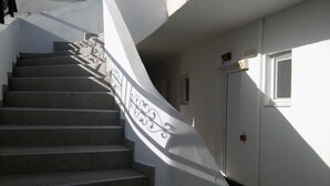 A staircase with a white railing and a door with a window.