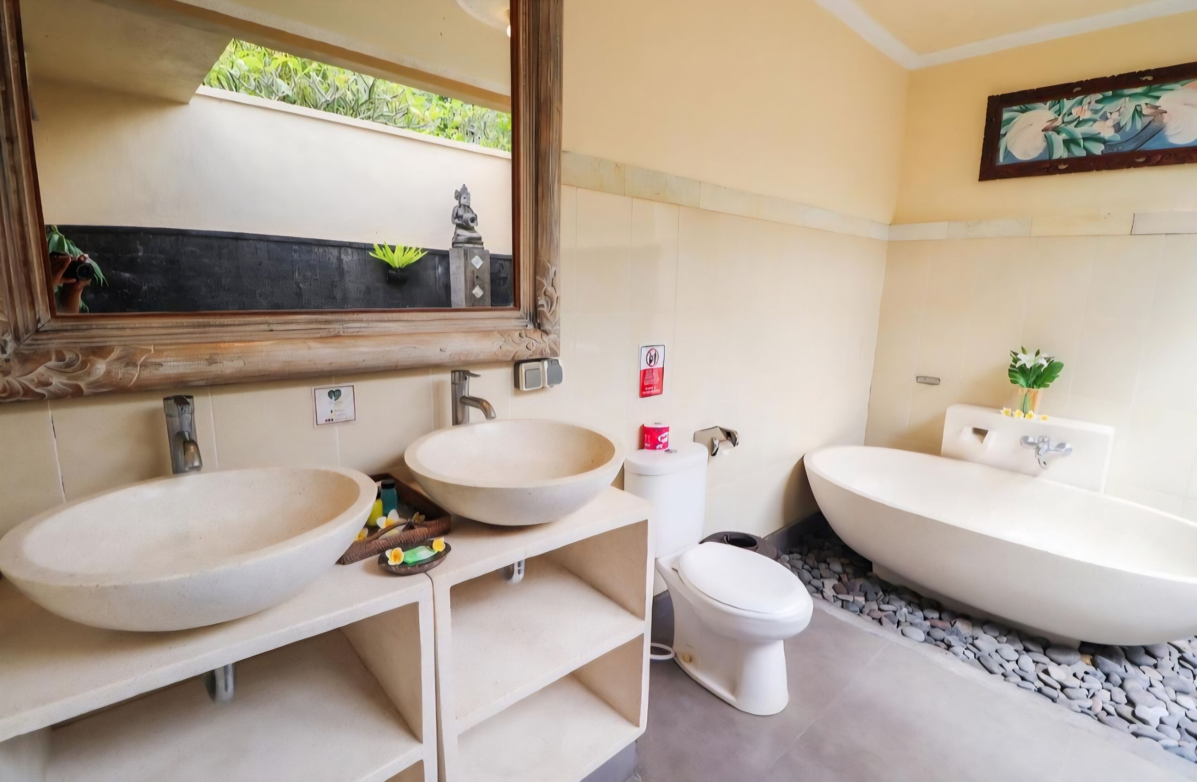 A bathroom with two sinks, a toilet, and a bathtub.