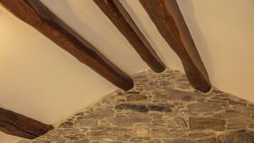 A stone ceiling with exposed wooden beams.