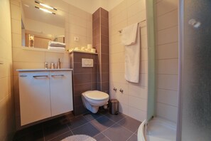 Shower, hair dryer, towels, toilet paper