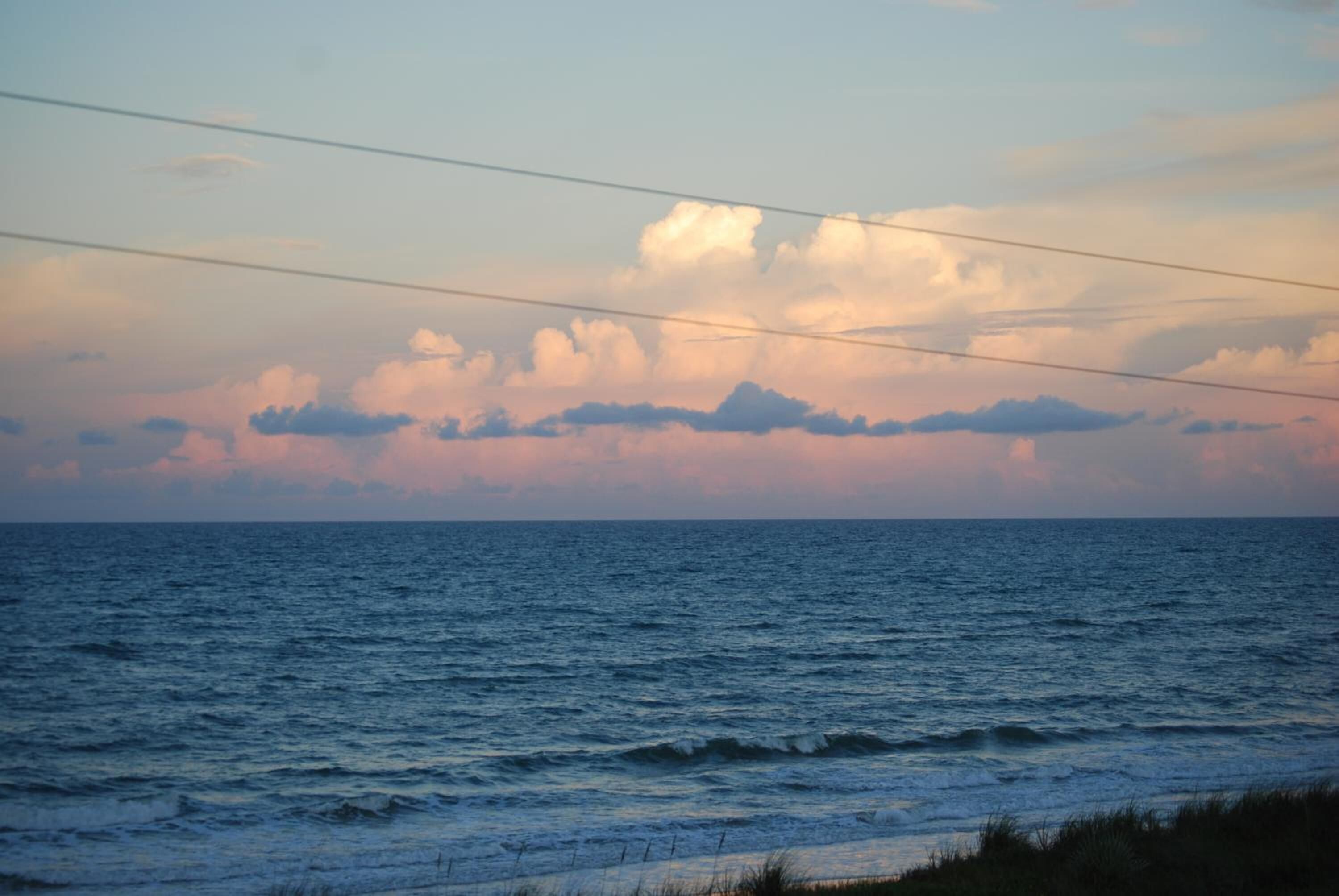 A coastal view with the ocean and a clear sky.
