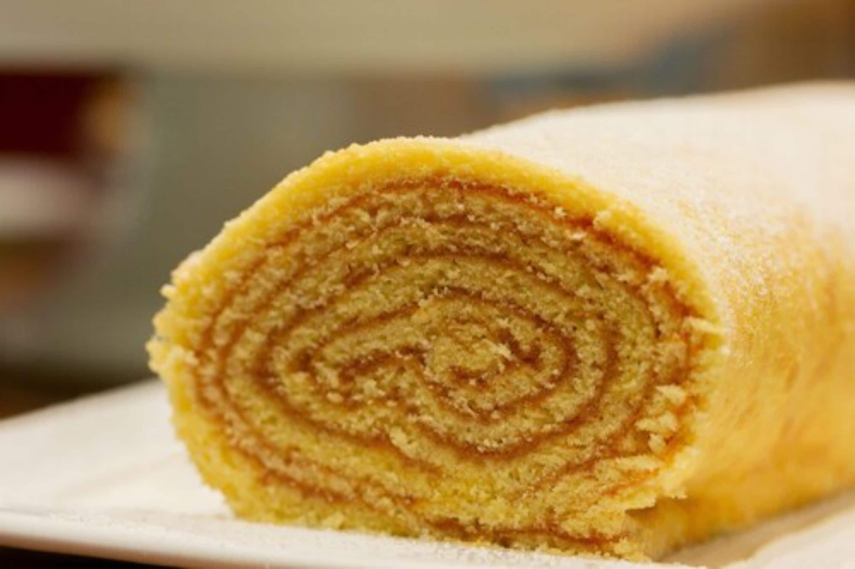 A rolled dessert with a spiral pattern.