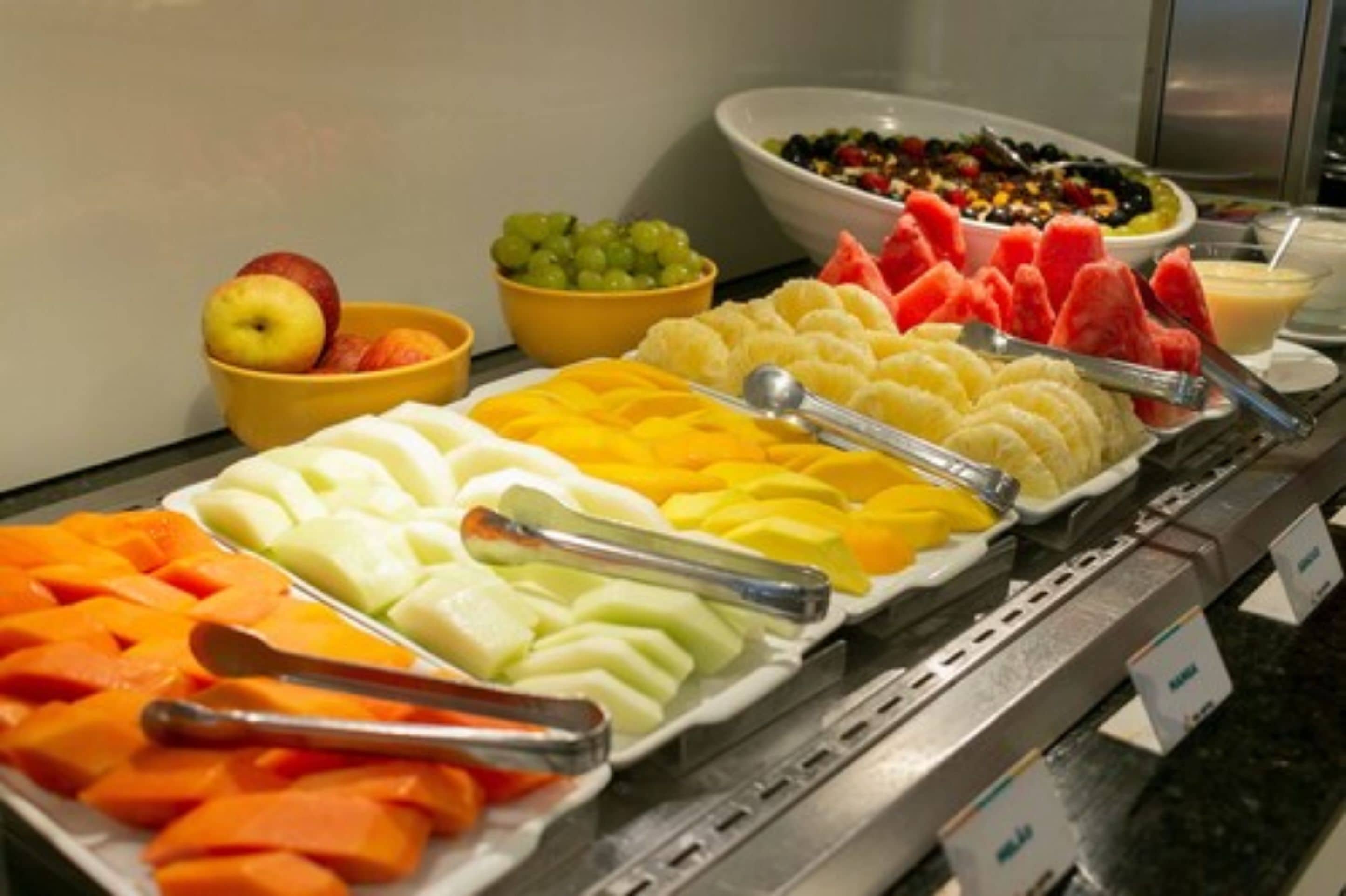 A buffet with various fruits and vegetables.