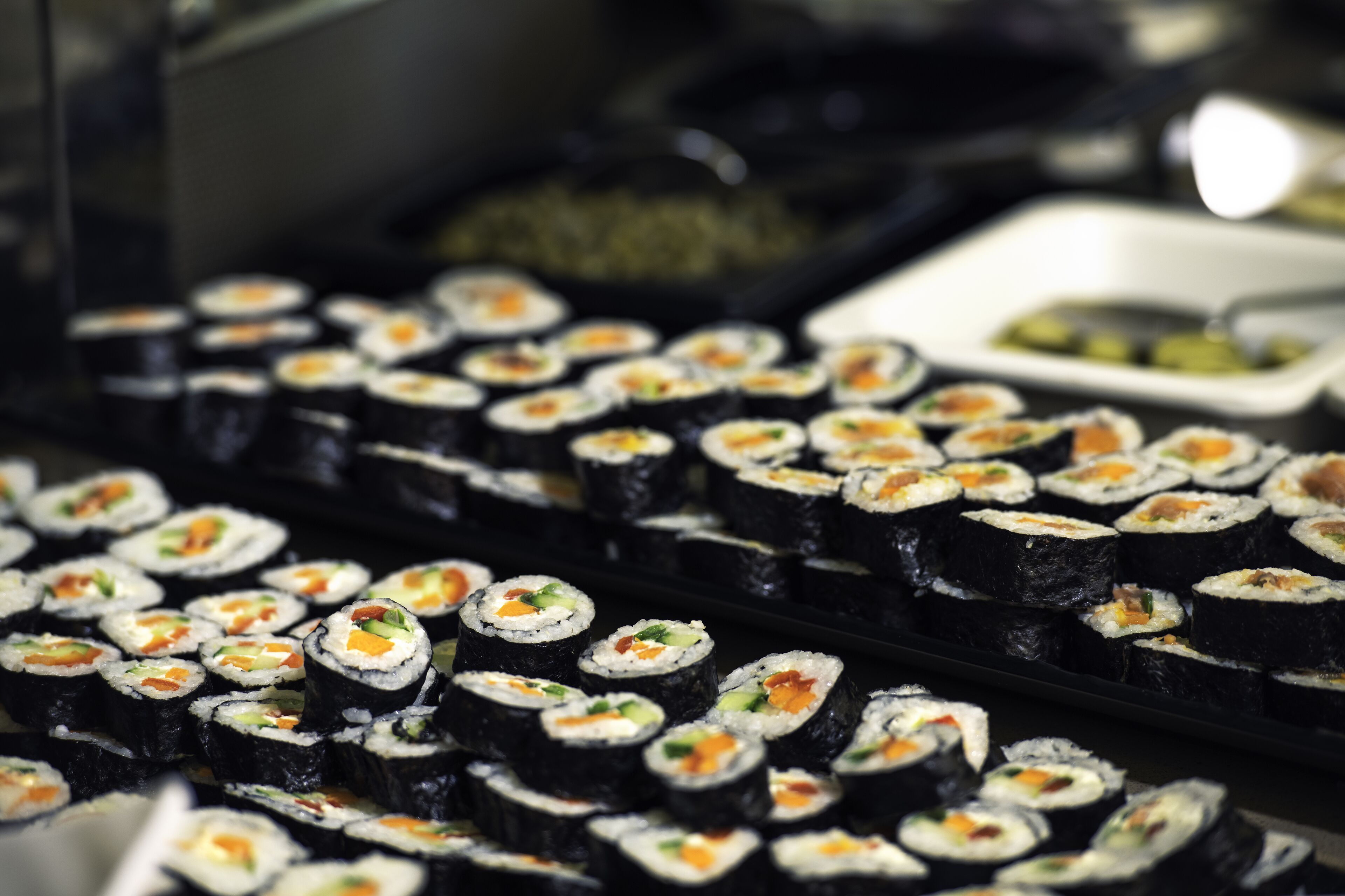 A display of sushi rolls with various fillings.