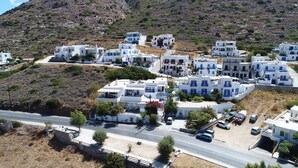 A coastal village with white buildings, narrow streets, and a hillside backdrop. - Boufounis Studios (Sifnos)