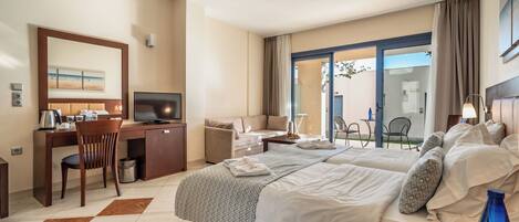 A hotel room with a bed, desk, chair, TV, and a view of the outdoors.