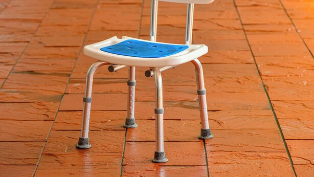 A mobility aid chair with a blue seat and backrest, four wheels, and a metal frame. - Hokuriku Fukui Awara Onsen Mimatsu (Awara)