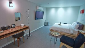 A modern hotel room with a bed, desk, chair, TV, and a small table. - Hotel The May (Gwangju)