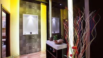Bathroom features a large mirror, decorative bowl, and a small window with an outside view.