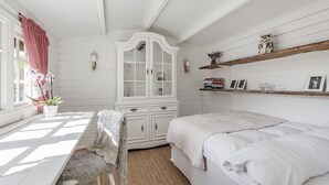 A room with a bed, a white cabinet, a desk, and a chair. - Swedish Idyll (Falkenberg)