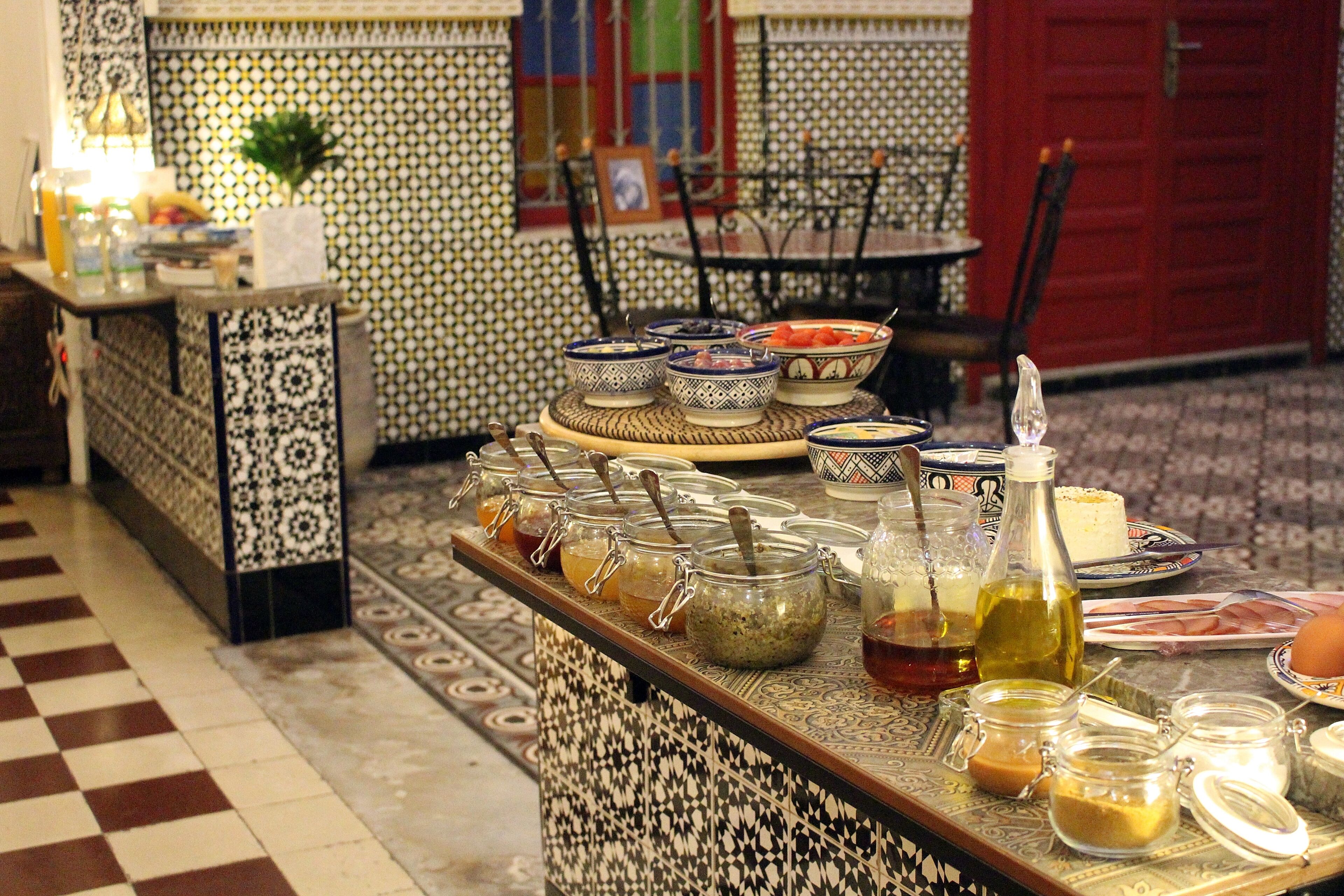A buffet table with various food items and condiments.