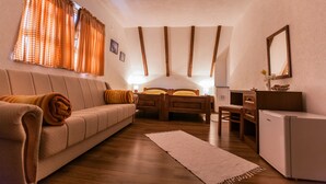 A cozy room with a sofa, a bed, a desk, and a small cabinet. - House Rustico (Plitvicka Jezera)