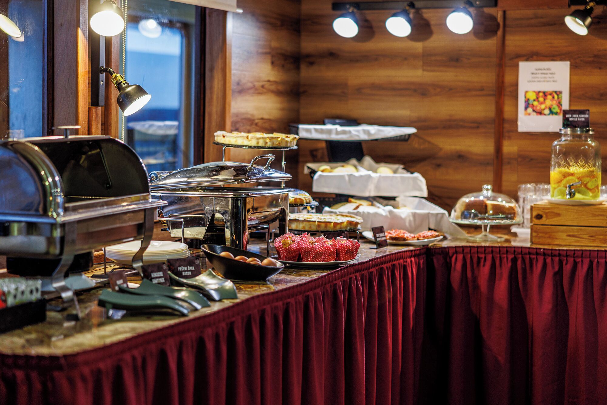 A buffet setup with various food items and a coffee station.