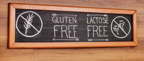 A framed sign with "GLUTEN FREE" and "LACTOSE FREE" written on it.