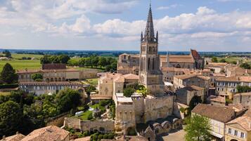 A historic town with a prominent church featuring a tall spire, surrounded by traditional buildings and a well-maintained public square.