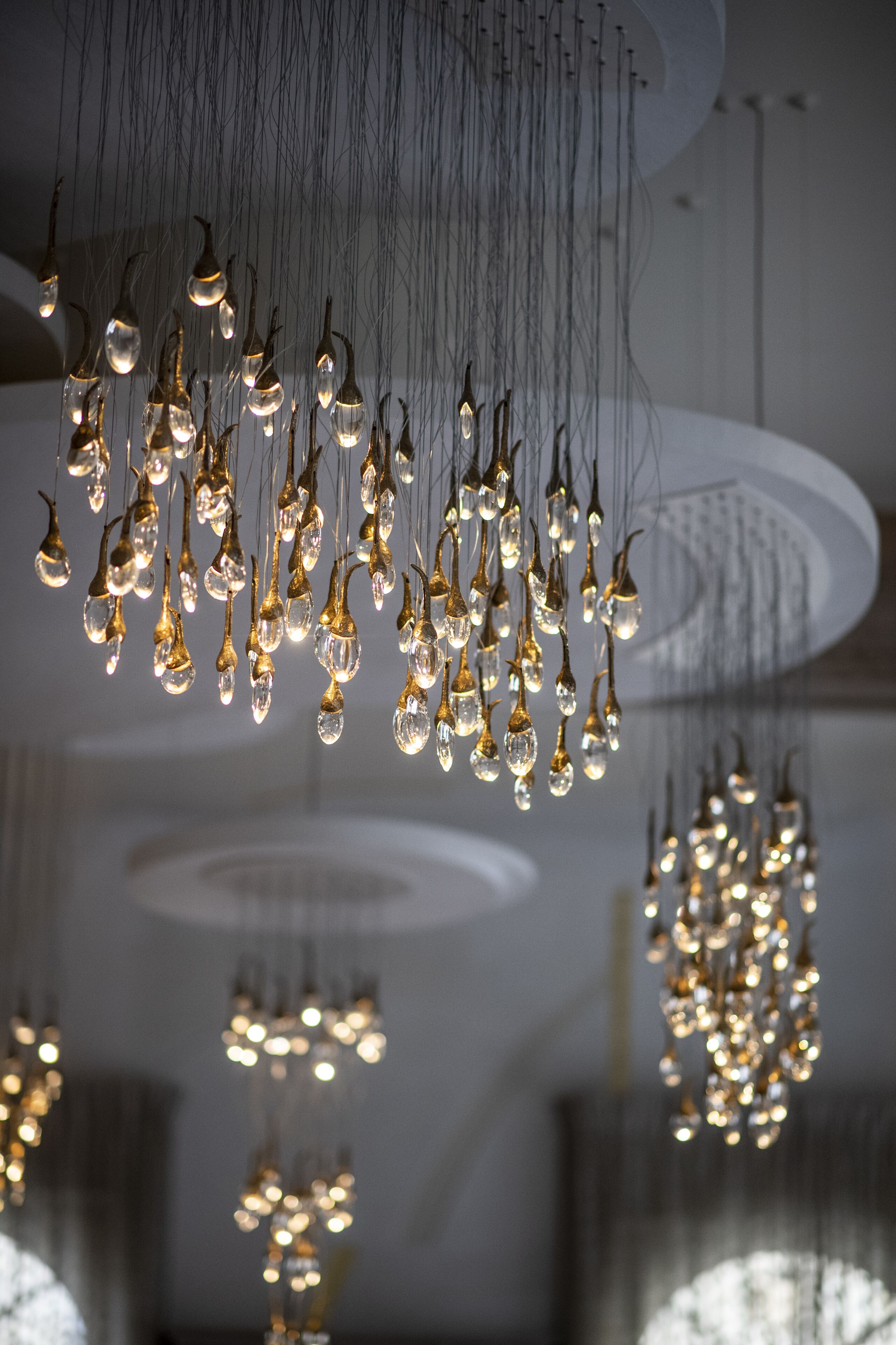 A modern interior with multiple hanging light fixtures.