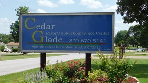 A sign for Cedar Glade Resort/Hotel/Conference Center with contact number and address. - Cedar Glade Resort (Horseshoe Bend)