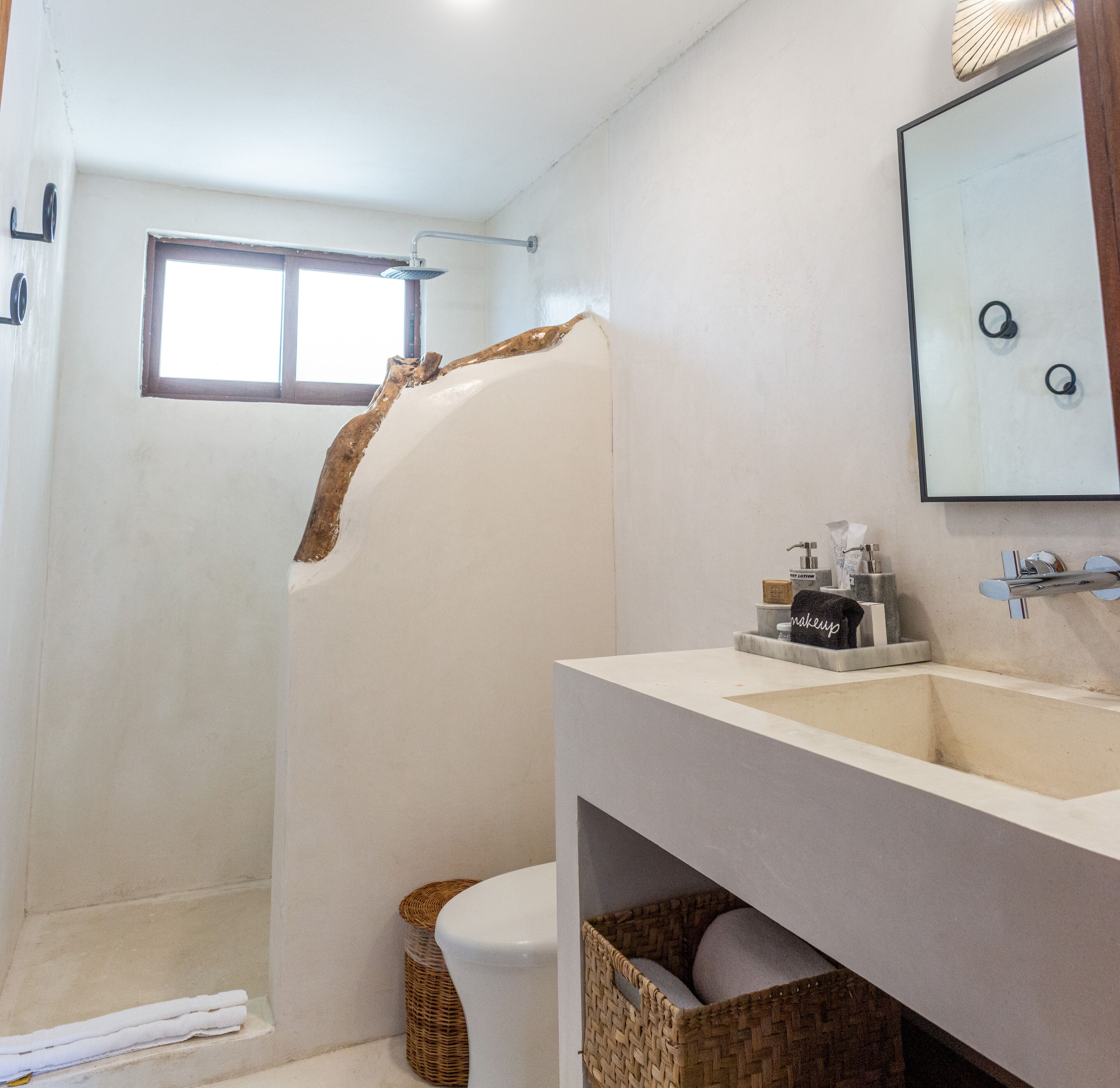 A bathroom with a shower, a sink, and a mirror.