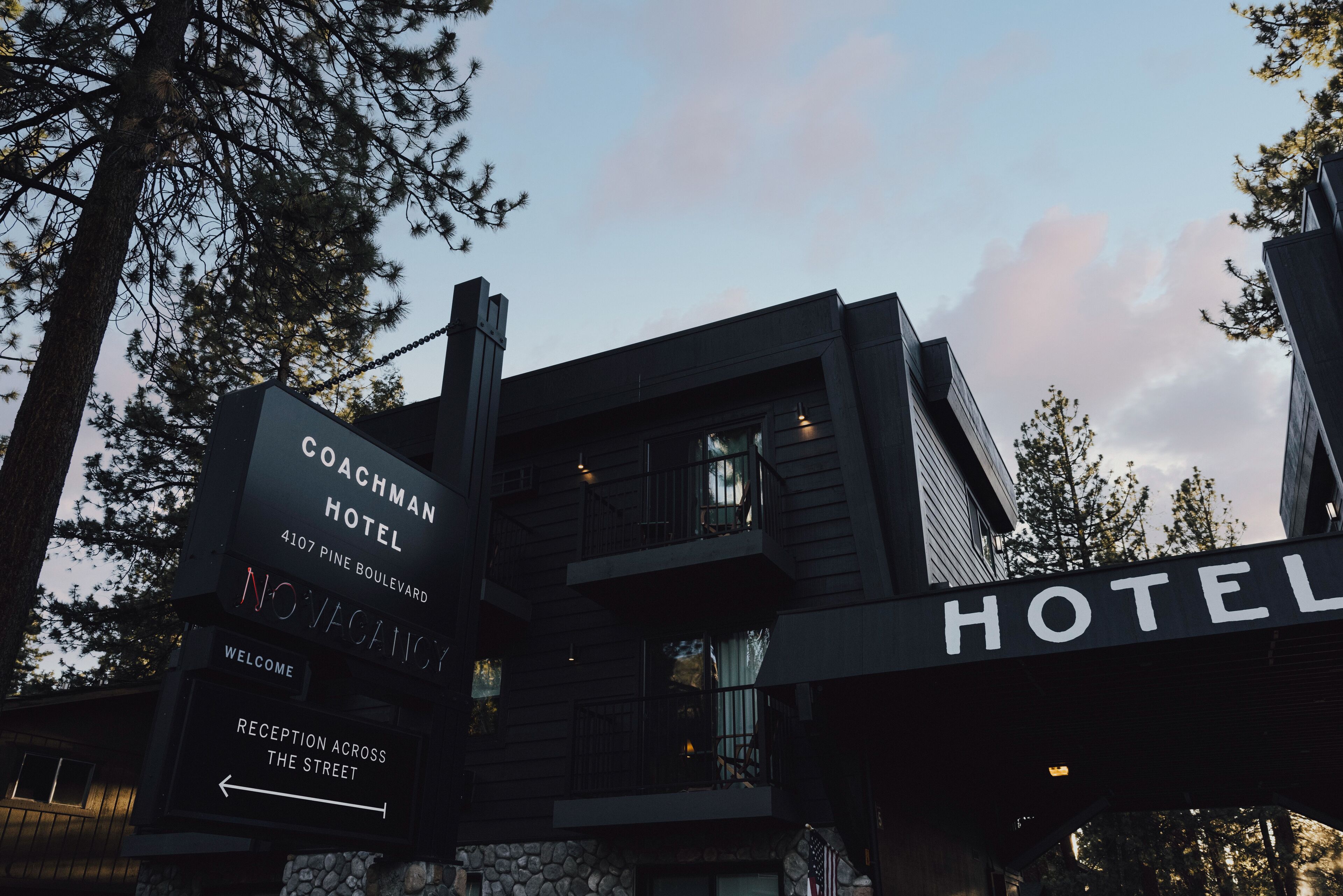 A hotel sign with "Coachman Hotel" and "Novascotia" written on it.