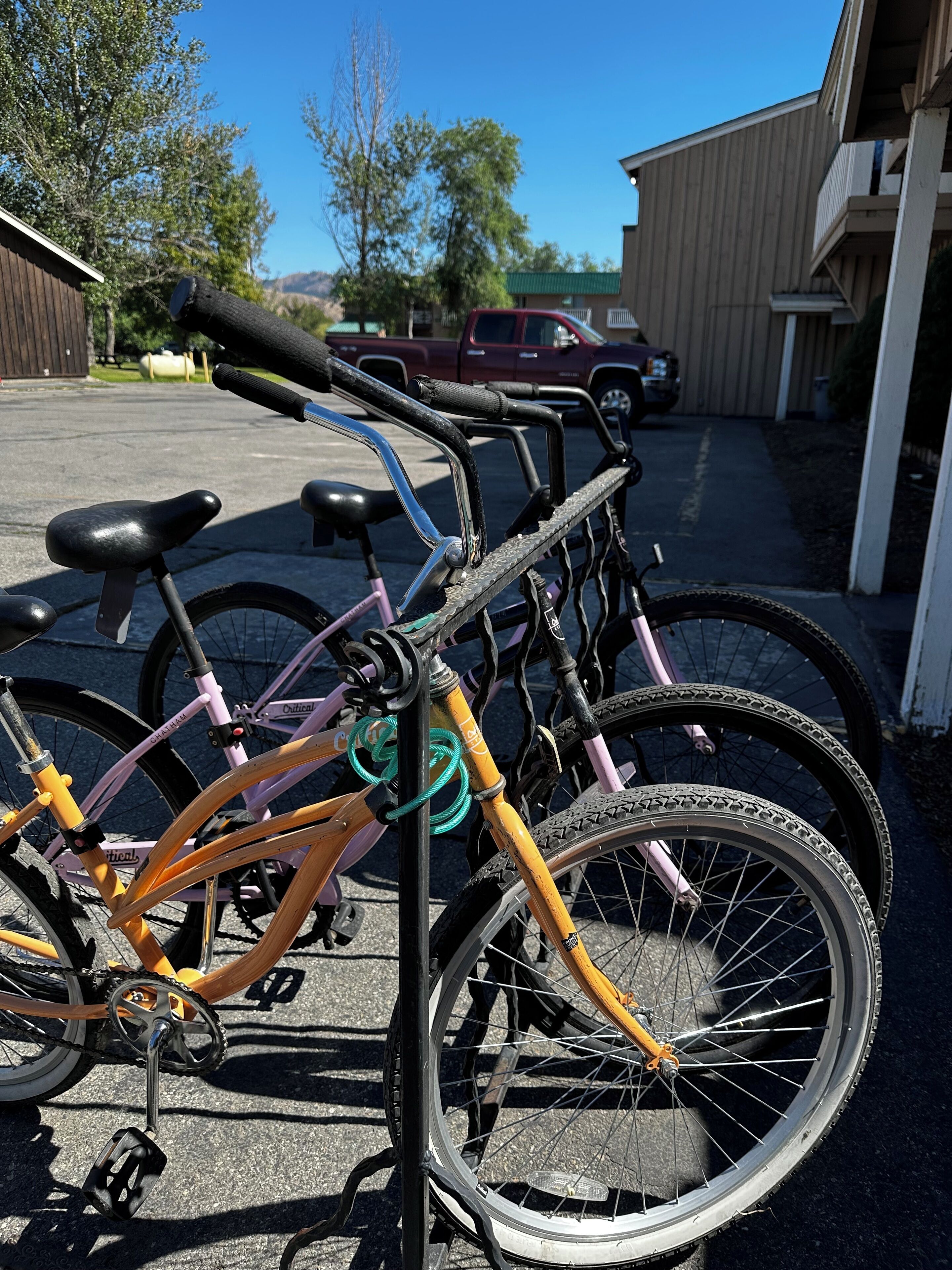 A bicycle rack with multiple bicycles parked.