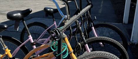 A bicycle rack with multiple bicycles parked.