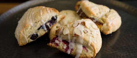 Three pastries on a dark plate.