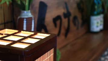 A wooden table with a decorative item and a sign with Japanese characters.