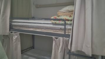 A bunk bed with a mattress and a pillow on top.
