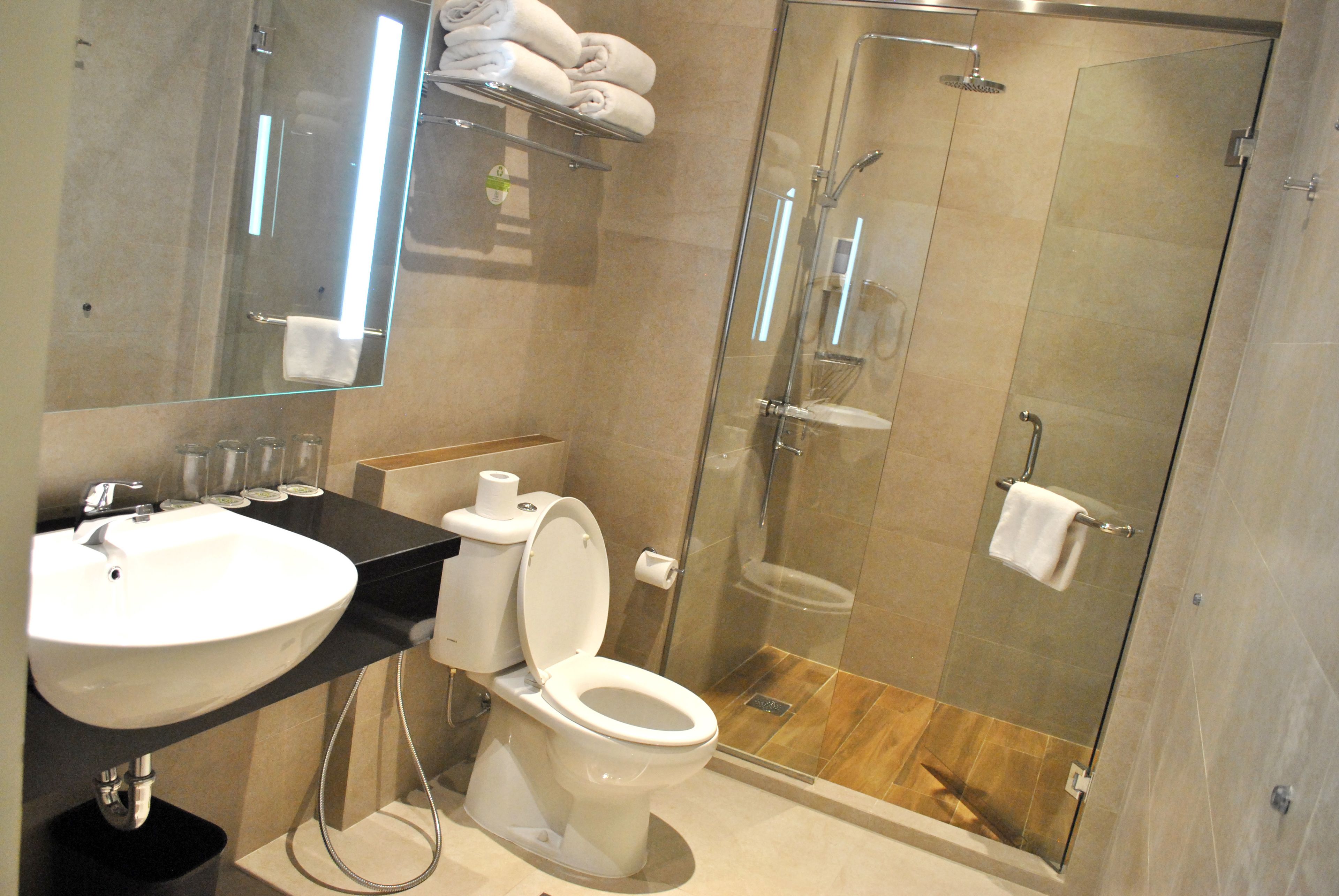 zest family room  | bathroom | shower, free toiletries, slippers, towels