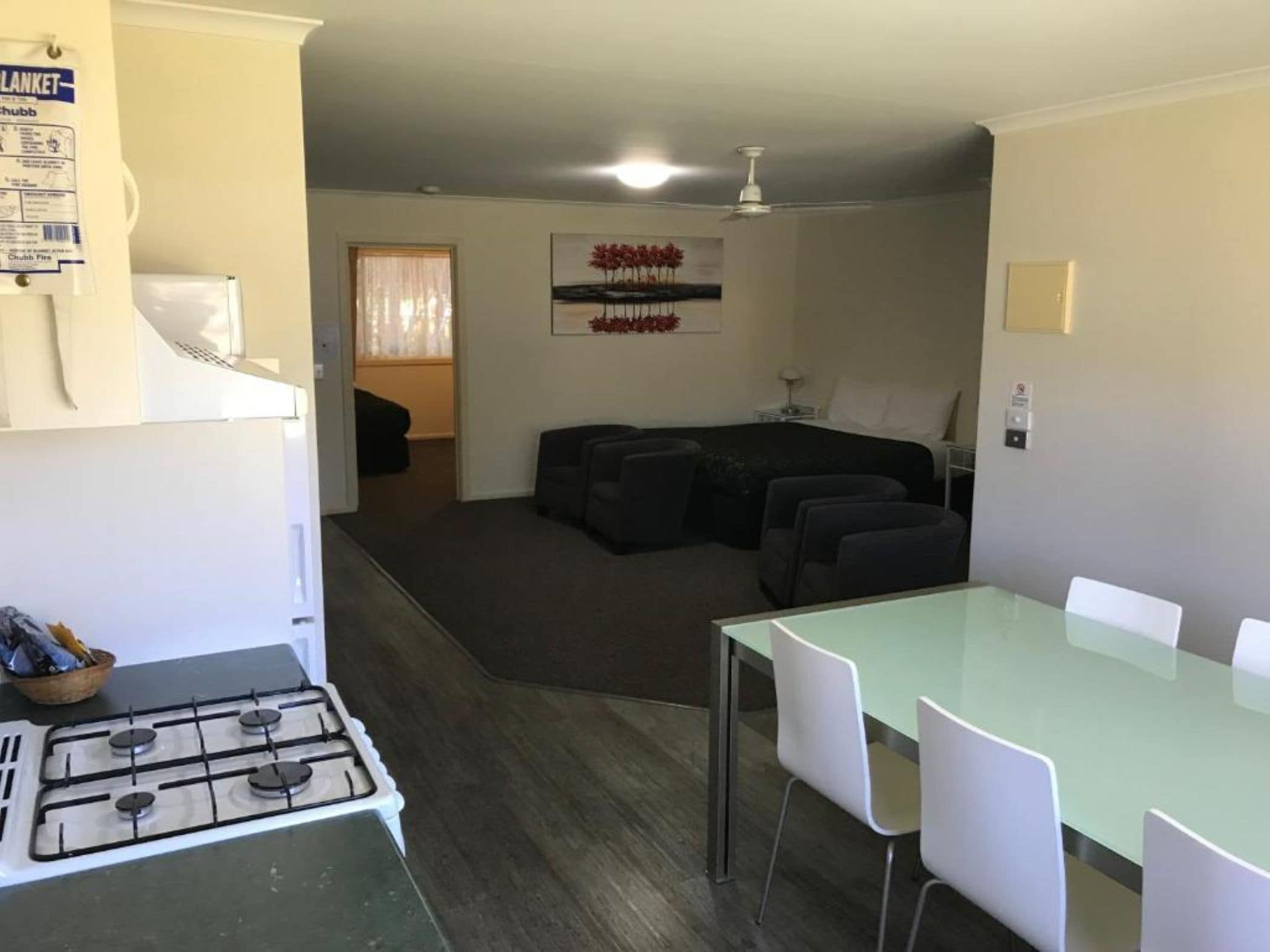A compact living space with a kitchenette, a dining area, and a living room.