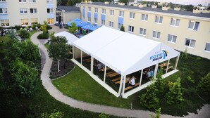 An outdoor seating area with a white tent labeled "HOTEL ZAWISZA" and a paved walkway. - Hotel Zawisza (Bydgoszcz)