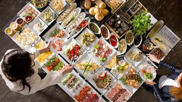 A top-down view of a buffet with various food items and condiments.
