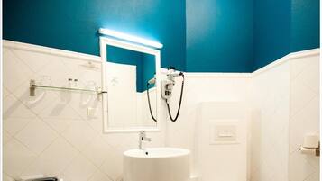 A bathroom with a bathtub, sink, and toilet.
