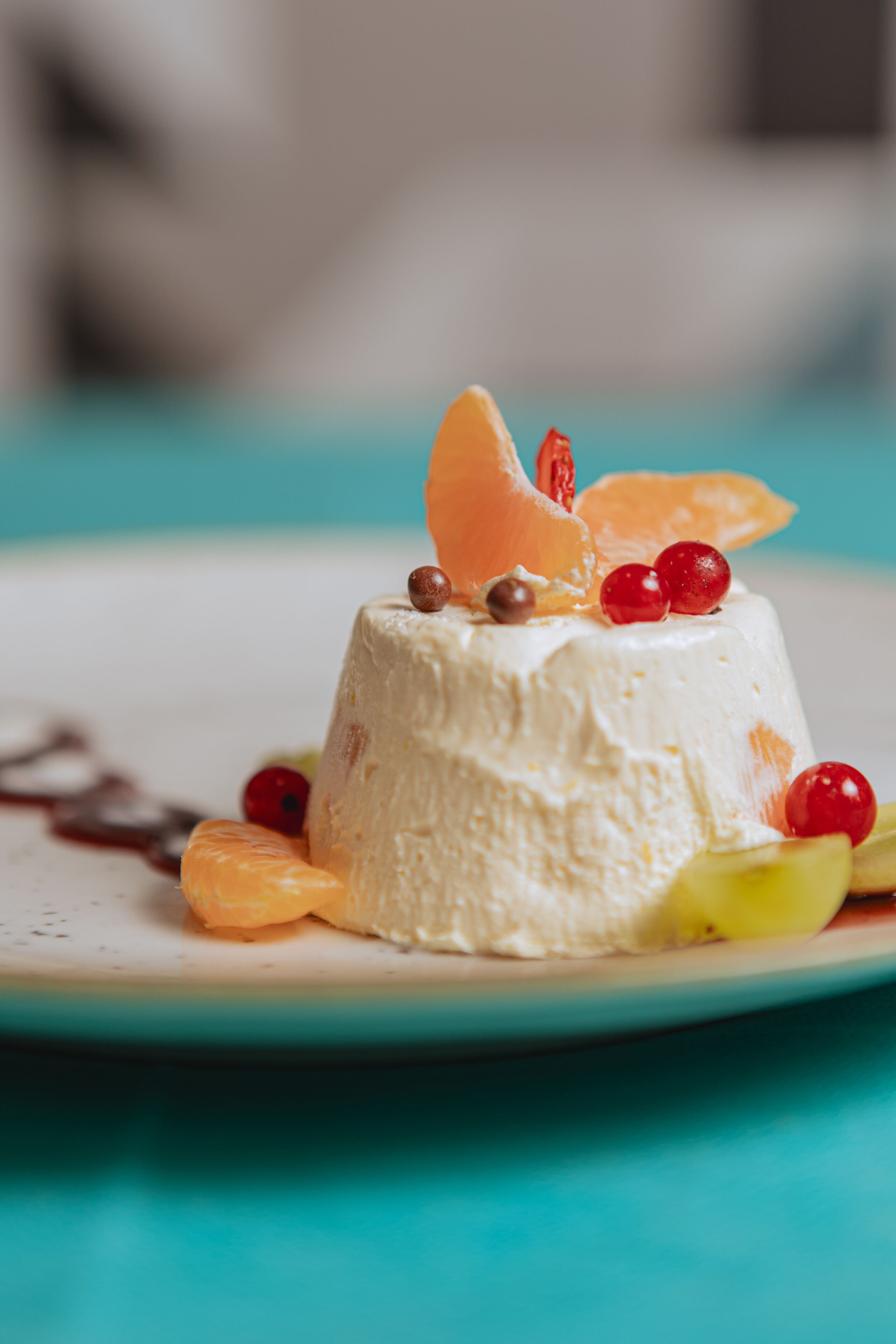 A dessert on a plate with a blue background.