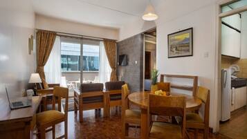 One Bedroom Executive Apartment | Living area | Flat-screen TV