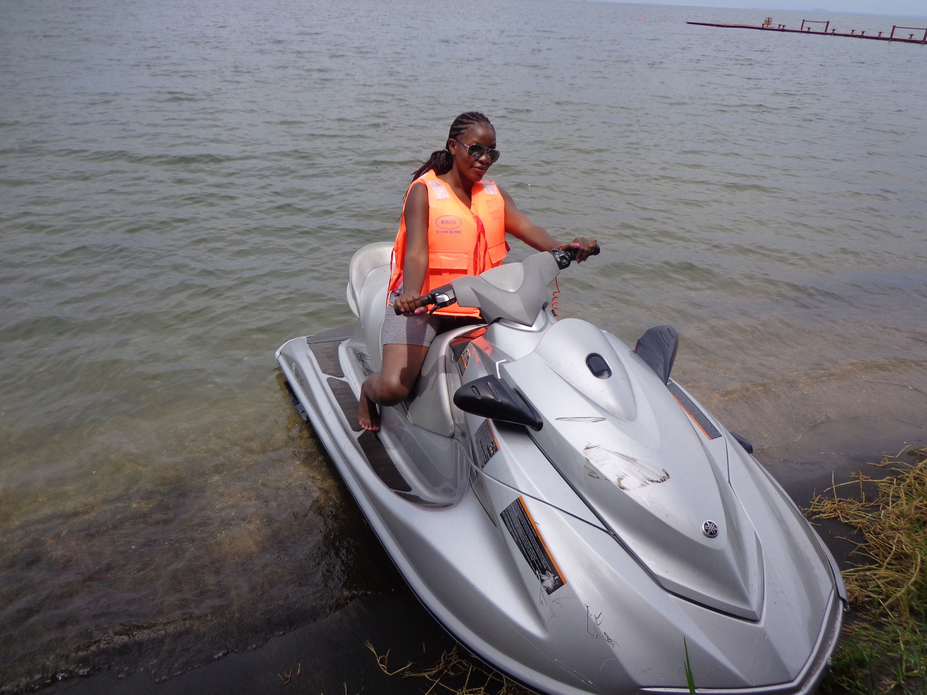 A person on a jet ski in shallow water.