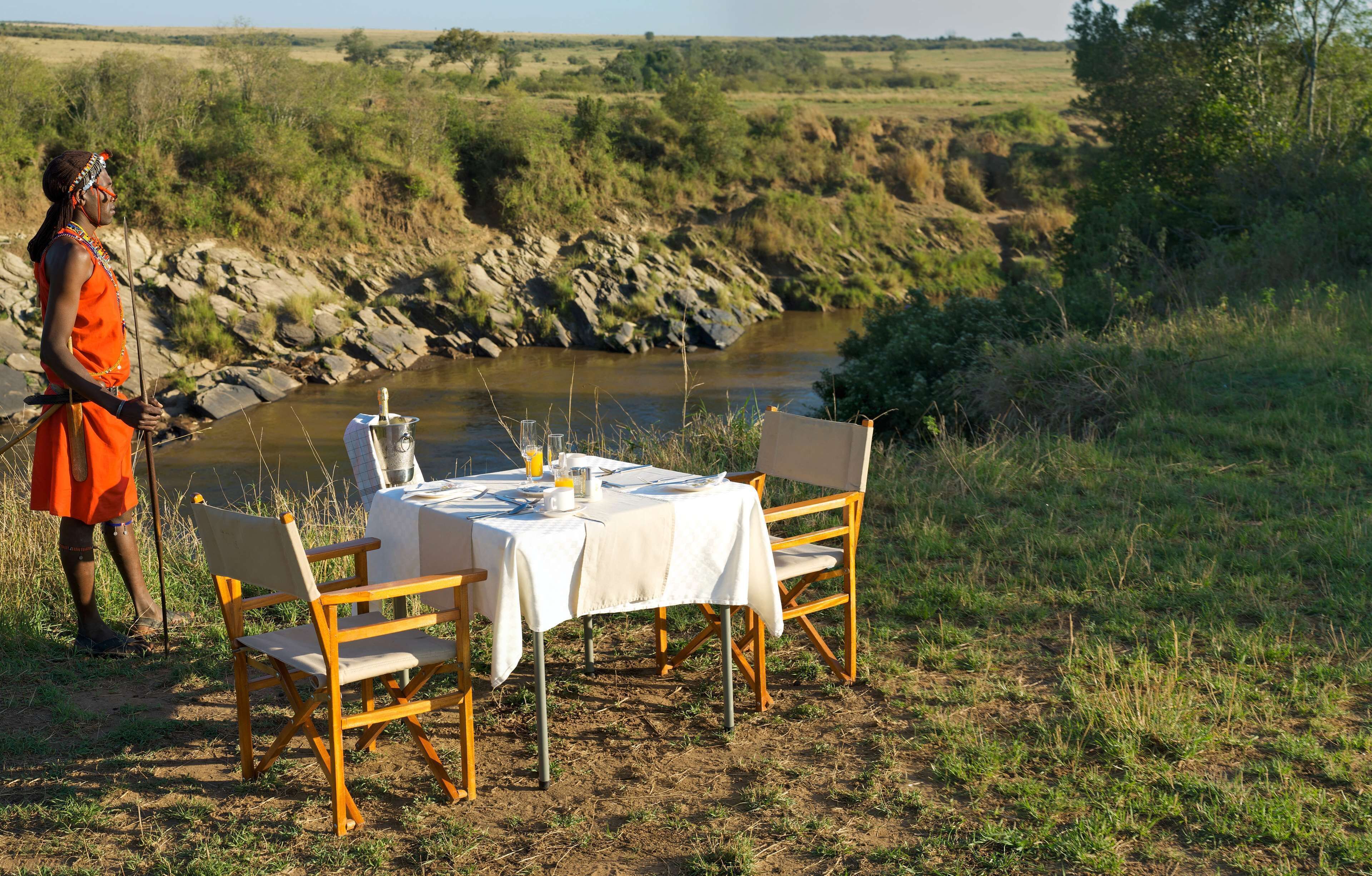 A table set outdoors with a river in the background.
