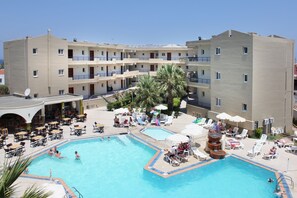 A hotel with a swimming pool, multiple balconies, and outdoor seating areas. - Sea Melody Beach Hotel & Apartments (Rhodes)