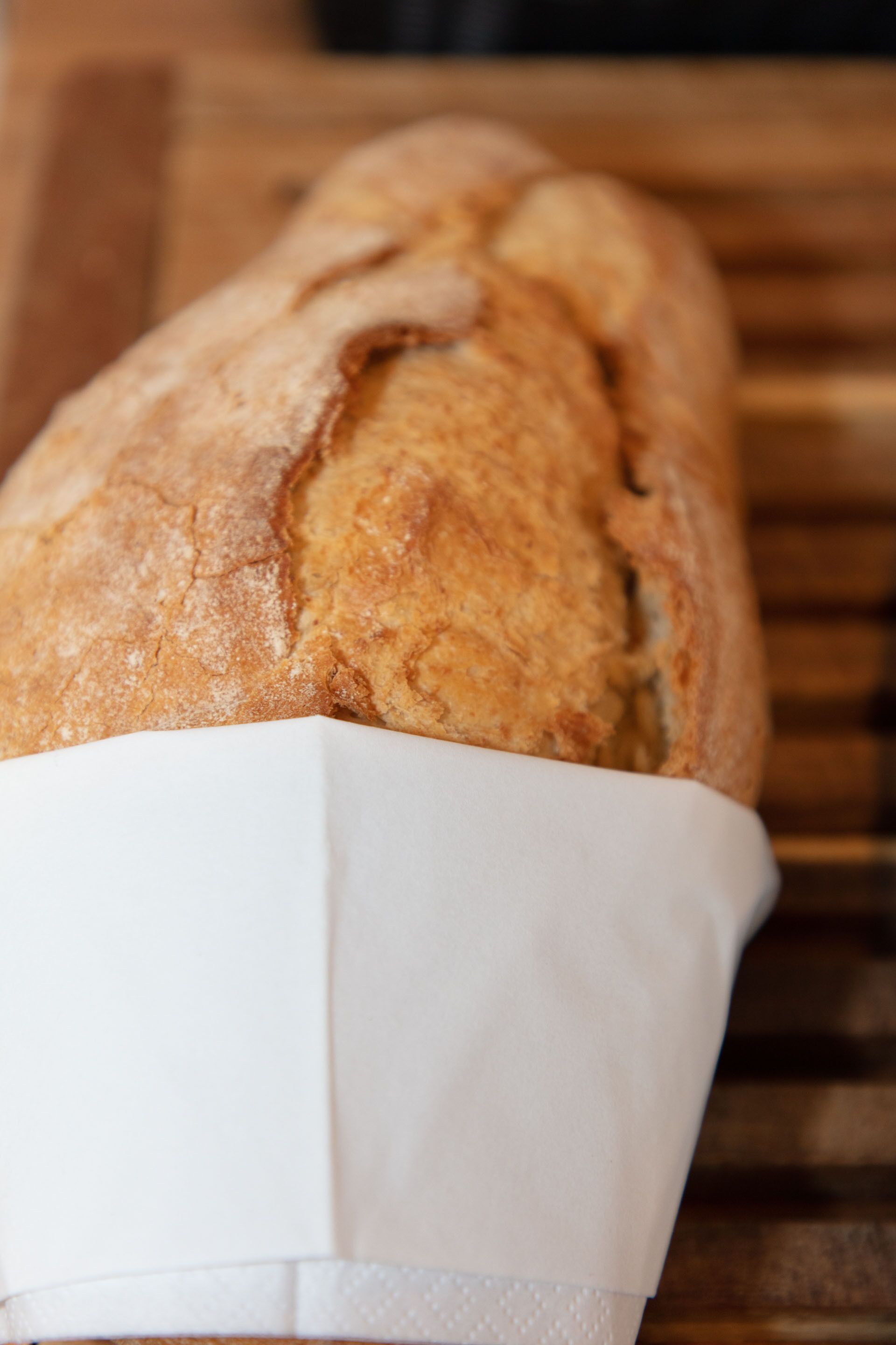 A loaf of bread in a paper bag.
